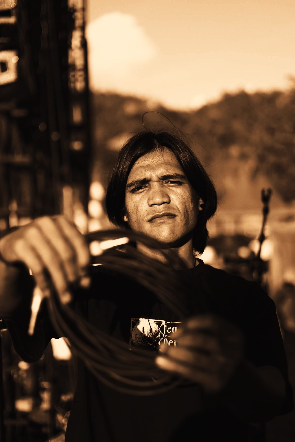Crew member coiling cable on a festival stage