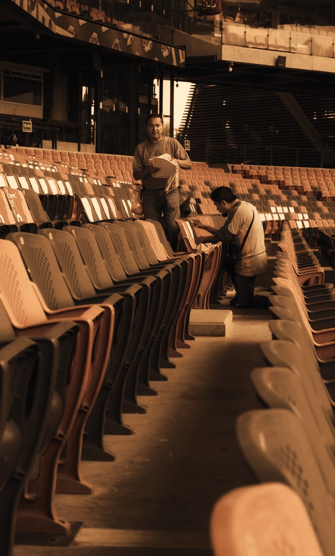 Venue staff preparing rows of stadium seating